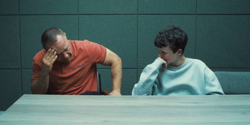 Stephen Graham as Eddie Miller and Owen Cooper as Jamie Miller sitting side by side in 'Adolescence'.