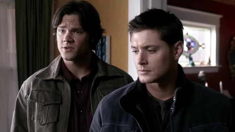 Sam (Jared Padalecki) and Dean (Jensen Ackles) standing next to each other on 