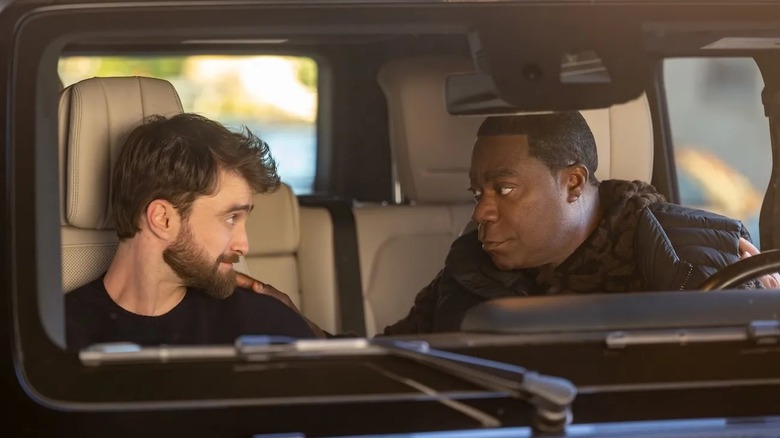 Arthur and Reggie looking at each other in a car in 