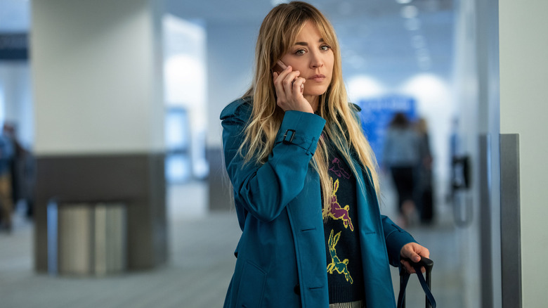 Kaley Cuoco talking on a phone at the airport in a scene from 