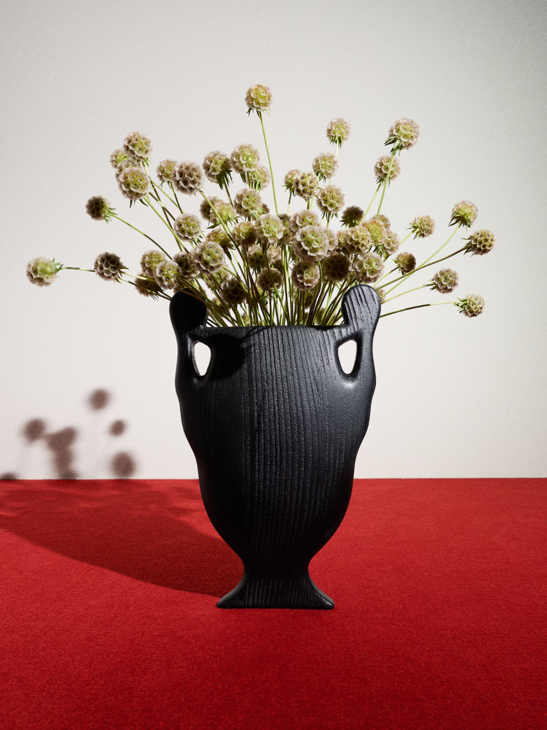 A black wood and glass vase from Kelly Wearstler x H&amp;M