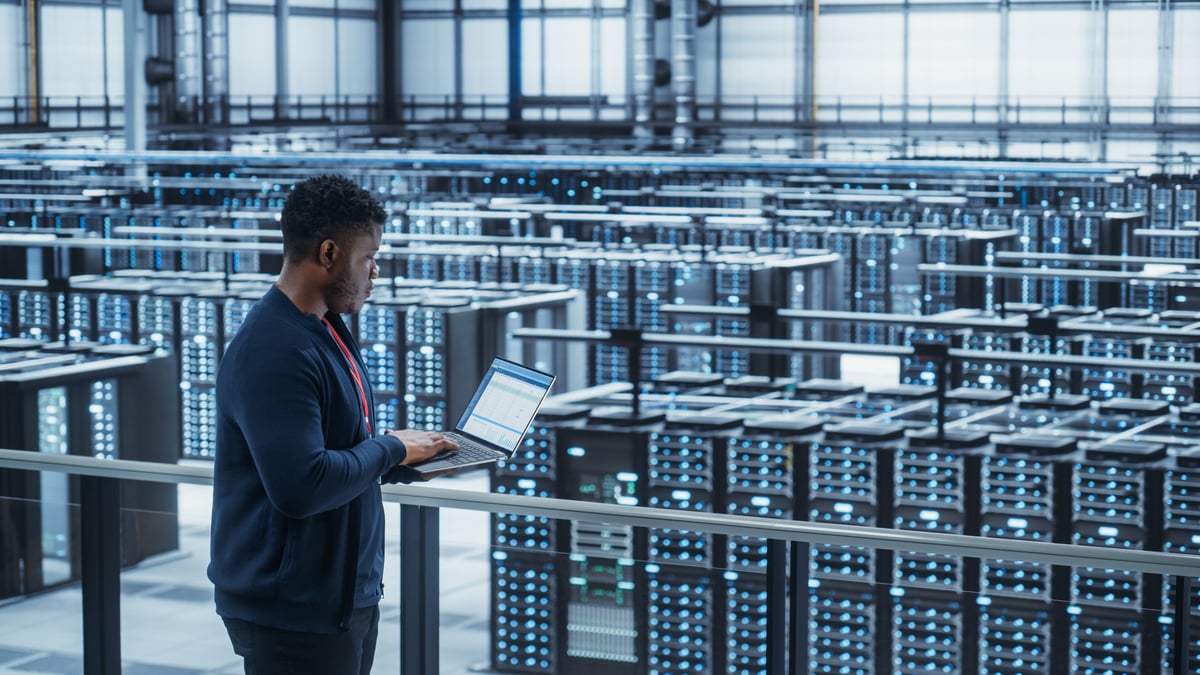 Tech overlooking a data center.