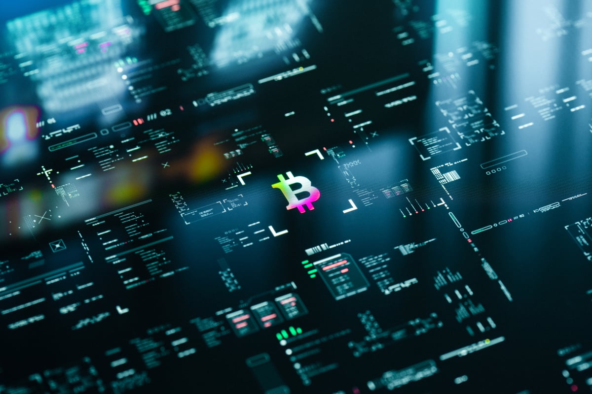 Neon glowing Bitcoin symbol on digital trading screen.