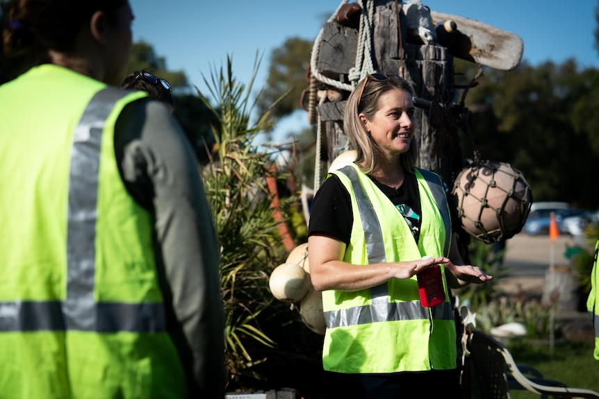 A woman wearing a yellow high-vis vest.