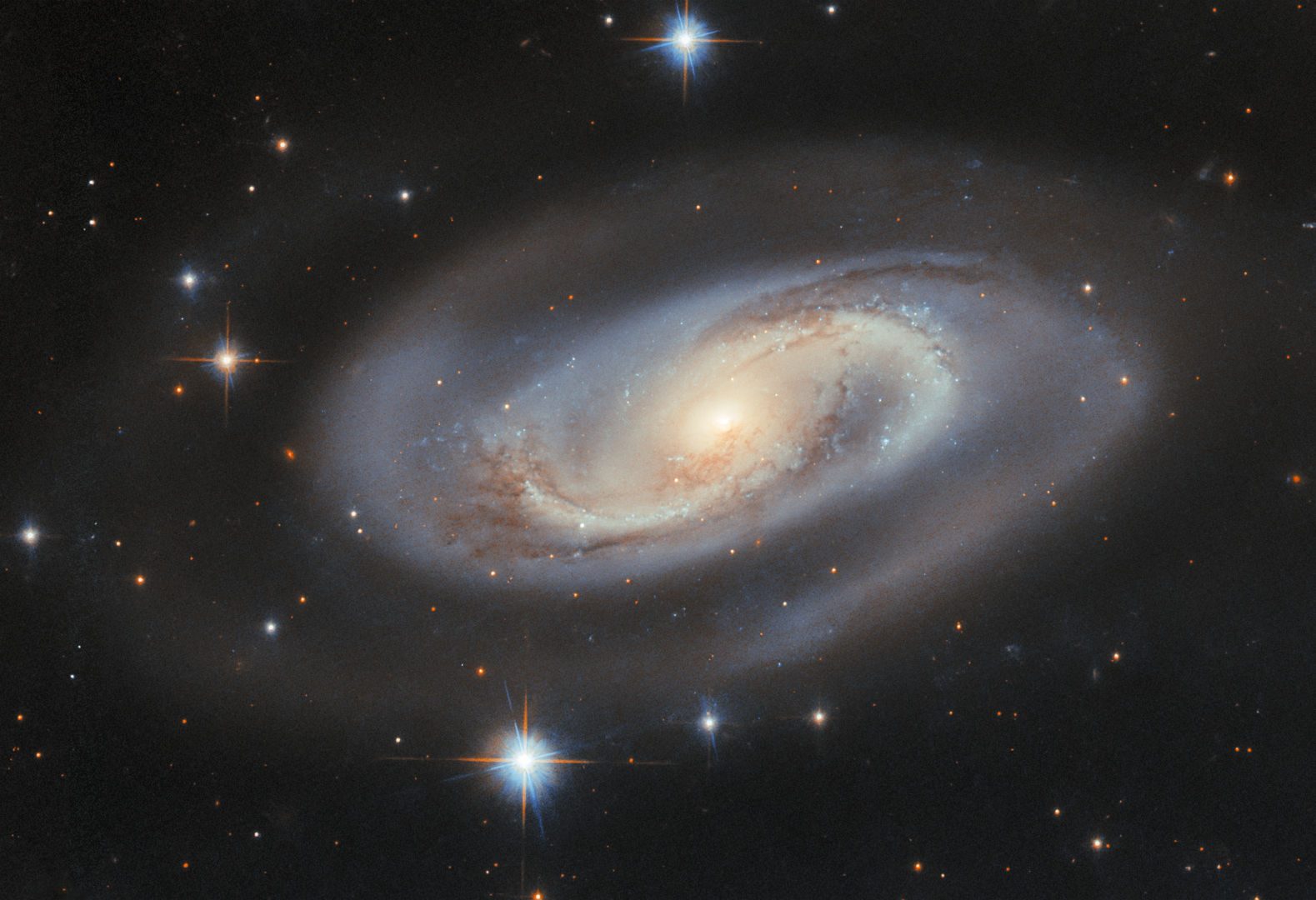Why don't spinning spiral galaxies fling themselves apart? Dark matter is holding them together, but no one knows what that is. Credit: ESA/Hubble & NASA, M. J. Koss, A. J. Barth