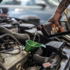 A mechanic pours motor oil into a funnel inside a Chevron Corp. gas station in Albuquerque, N.M., in July 2016. The cost of group III base oil, used in motor oil blends, more than tripled since the start of the war with Iran, according to the market insight firm Independent Commodity Intelligence Services.