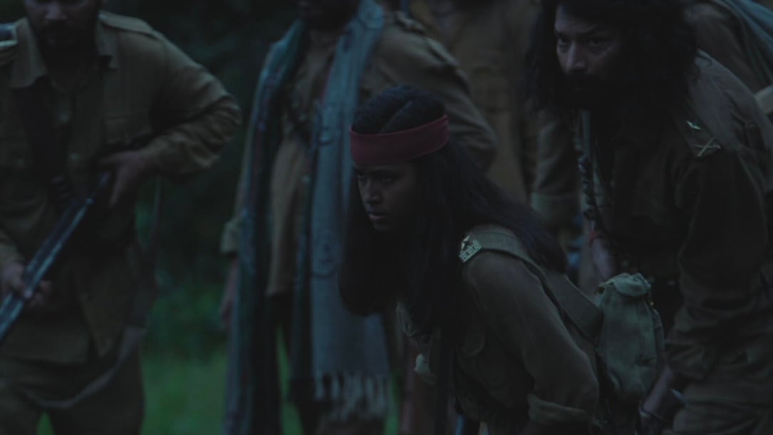 a young Indian girl and other bandits crouching down in the dark.