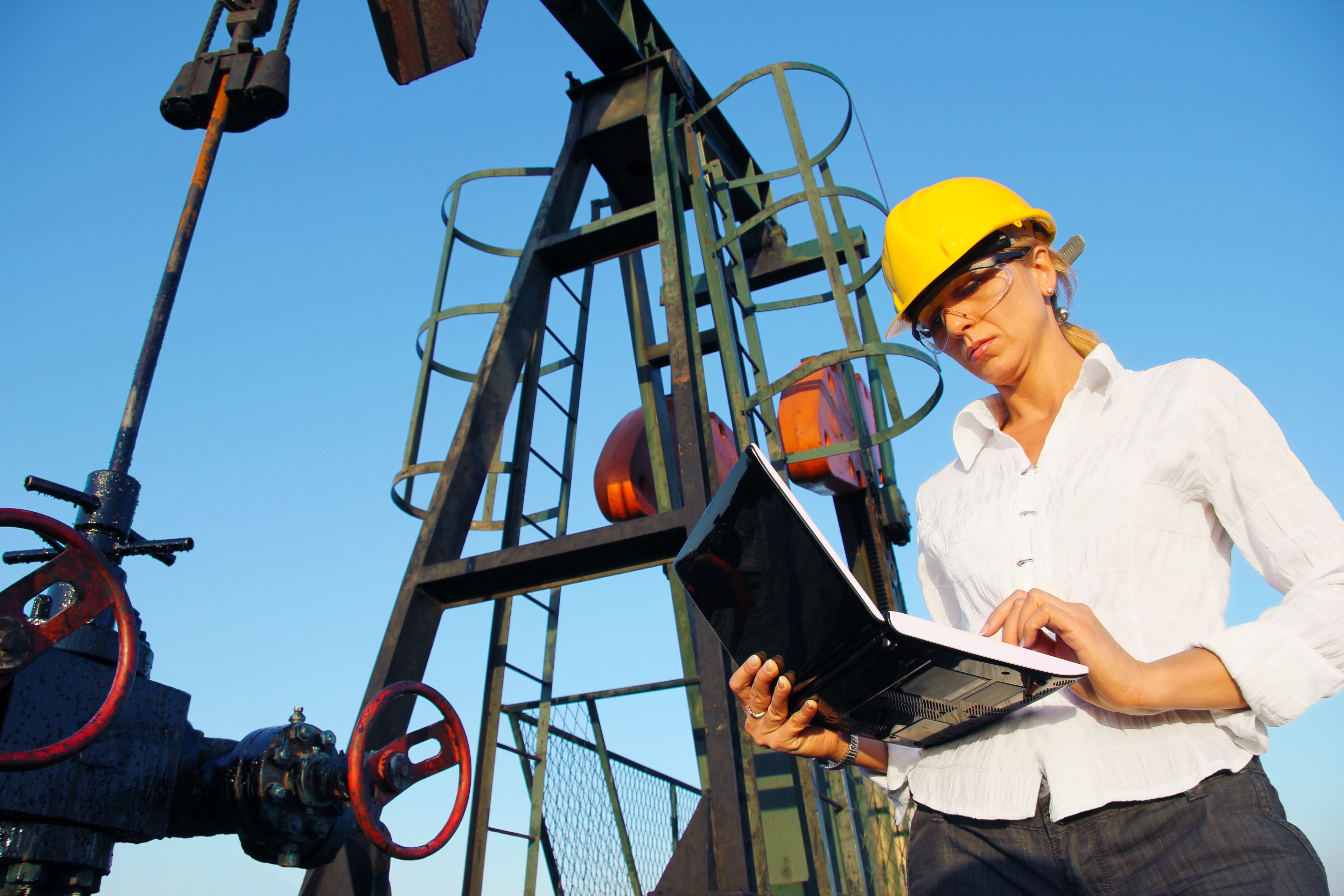 A person in front of energy infrastructure.