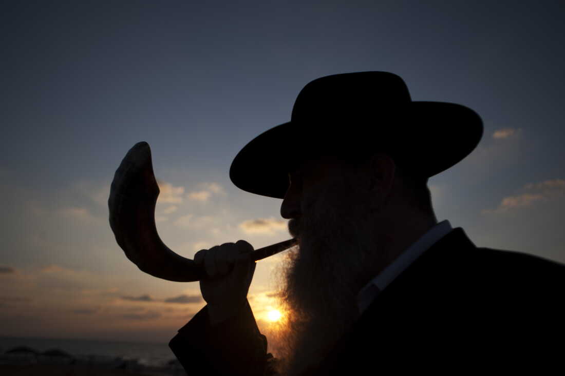 A Jewish man blows a shofar, or Ram's horn, during a Rosh Hashanah ritual in Israel.