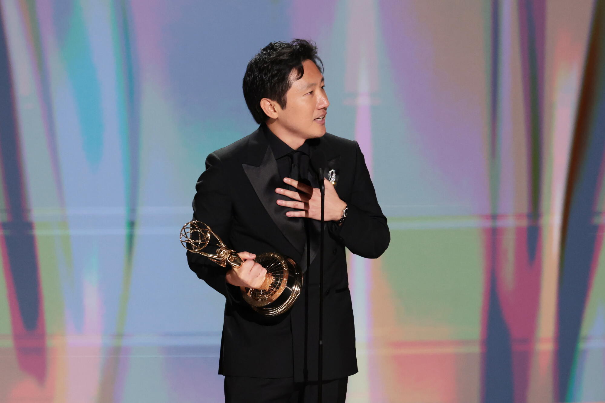 Hiro Murai accepts the Emmy for directing for a comedy series for "Widow's Bay" during the 78th Emmy Awards.