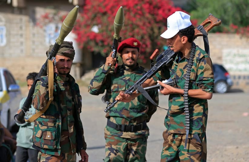 Fighters loyal to the Houthi authorities, brandish their weapons during a rally to recruit more fighters, in Sanaa on September 10, 2026.