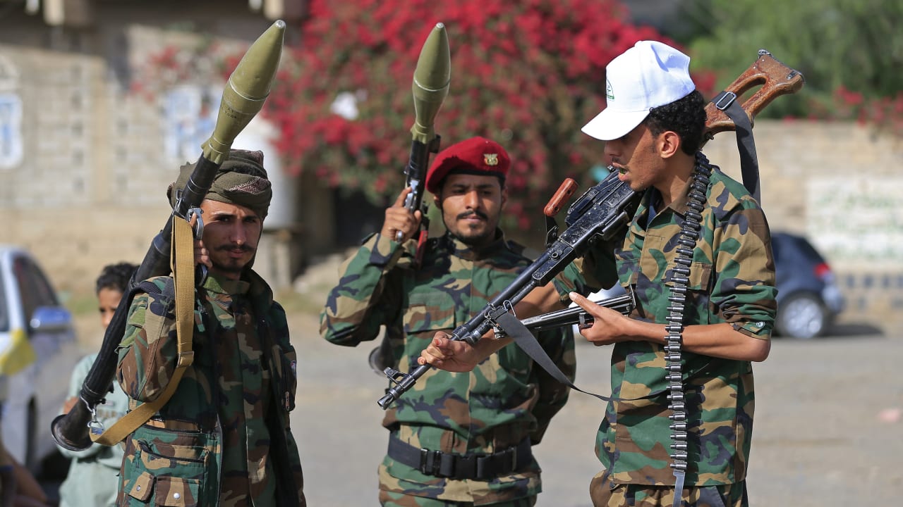 Fighters loyal to the Houthi authorities, brandish their weapons during a rally to recruit more fighters, in Sanaa on September 10, 2026.