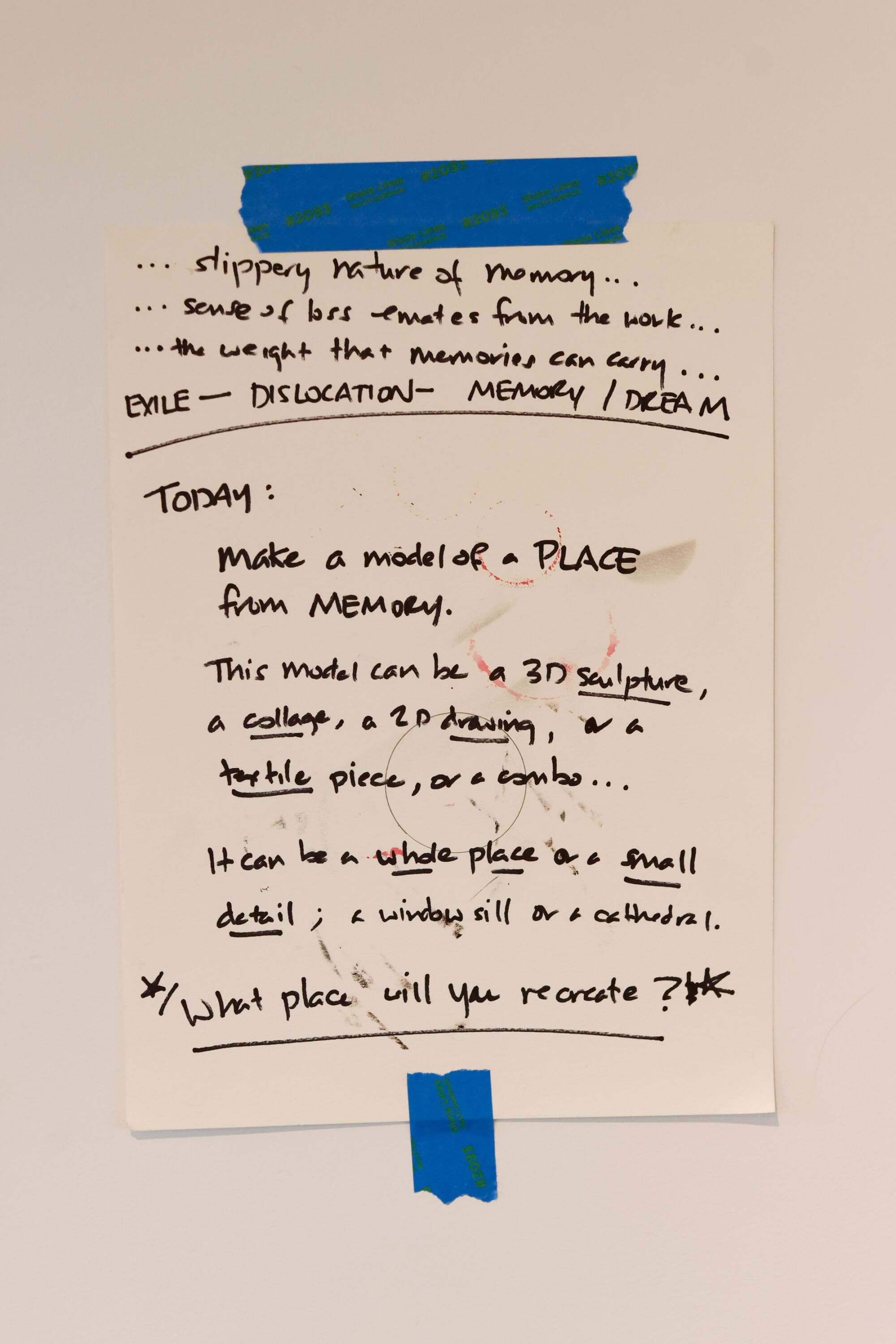 Instructions tapes to a wall for an art project.