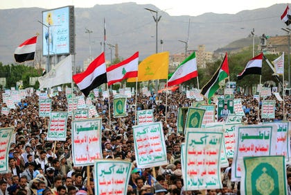 Supporters of the Houthi authorities hold flags during a protest against the Saudi intervention in Yemen and against Saudi Arabia's recent accusation that the Houthis fired at the holy city of Mecca, in Sanaa on Saturday. Credit: AFP/MOHAMMED HUWAIS Supporters of the Houthi authorities hold flags during a protest against the Saudi intervention in Yemen and against Saudi Arabia's recent accusation that the Houthis fired at the holy city of Mecca, in Sanaa on Saturday.