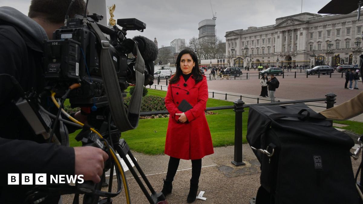 Maryam Moshiri stand in a black coat. The Vatican is in the background