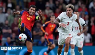 Spain midfielder Rodri and England defender Nico O'Reilly battle for possession