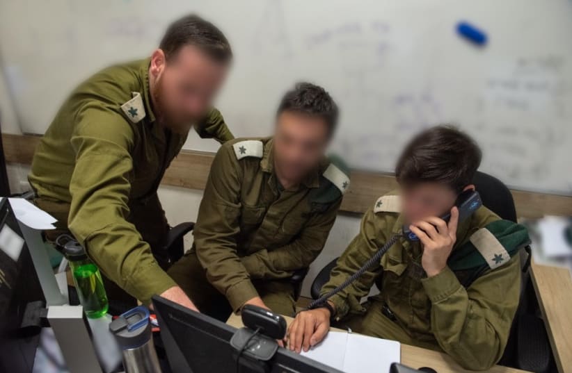  IDF soldiers are seen working as part of the Israeli military's Gaza battlefield intelligence collection unit.