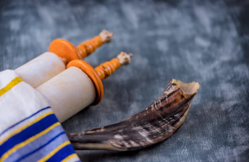 An illustrative image of a Torah scroll and a shofar for Yom Kippur.