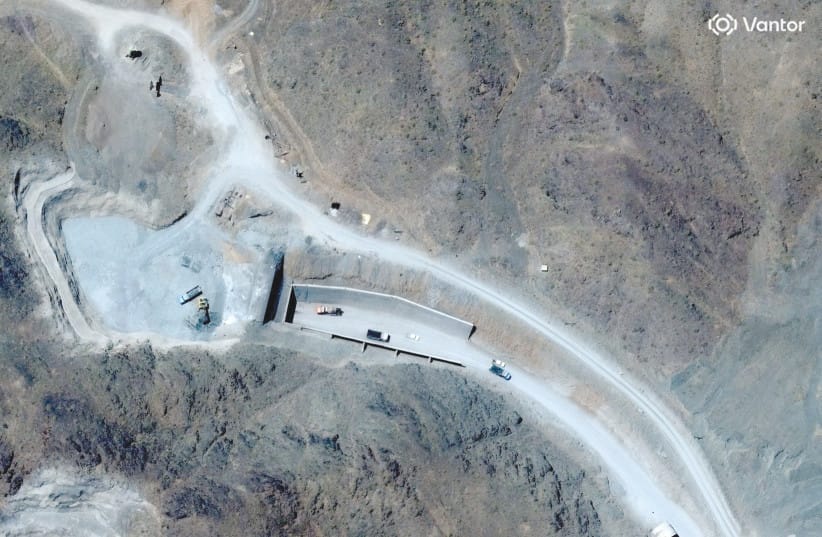 SATELLITE VIEW shows vehicles at an entrance to Pickaxe Mountain tunnels, near Natanz nuclear facility, in Iran, June 21.