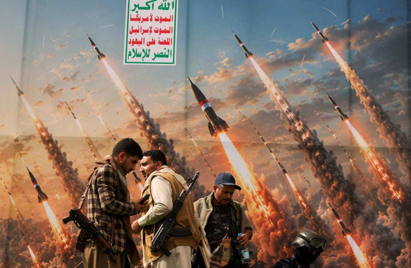 Houthi activists stand on a platform against a banner depicting Houthi missiles, at an anti-Saudi rally amid an escalation with the kingdom, in Sanaa, Yemen, July 31, 2026. 
