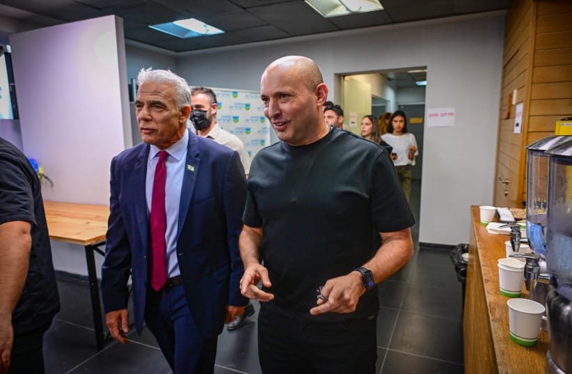 Former Prime Minister and Together party leader Naftali Bennett is seen with Opposition Leader Yair Lapid as they arrive for a press conference as part of the B'Yachad party election campaign in Tel Aviv, central Israel, August 19, 2026.