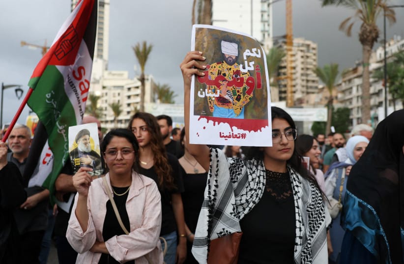 Women hold posters during a march to commemorate the first anniversary of the pager explosions in Beirut, Lebanon, September 17, 2025.