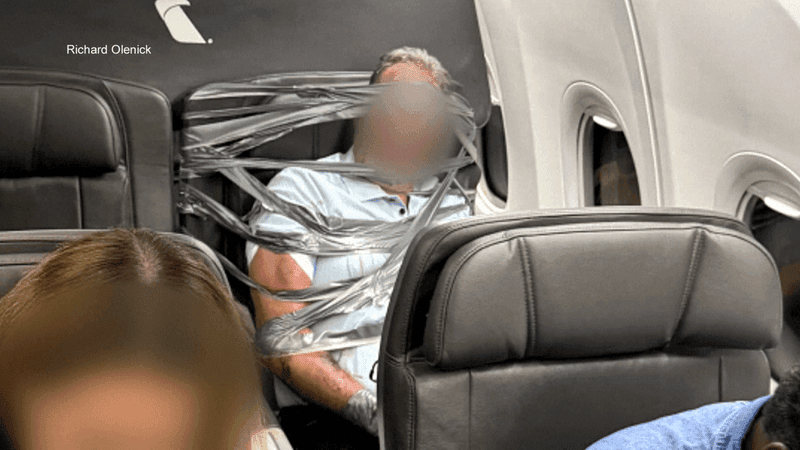New images obtained by 7News show 67-year-old Arthur Lundeen restrained to his airplane seat with duct tape and zip ties before an American Airlines flight diverted to BWI. He was arrested on Maryland state charges. (Richard Olenick)