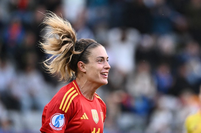 Alexia Putellas Alexia Putellas celebrates in a red and gold Spain kit.