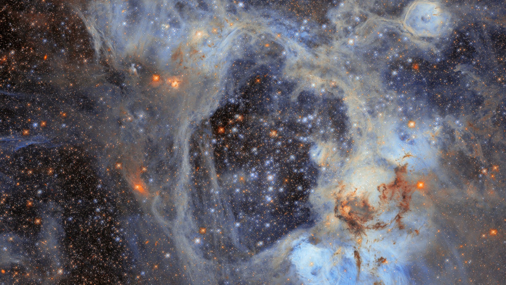 Lots of sparkles and glowing dots among smoky tendrils of gas.
