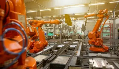 Robotic arms inside an industrial manufacturing facility.