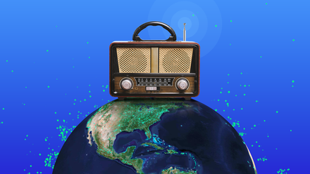 A vintage radio sits on top of a globe surrounded by green Radio Garden station dots