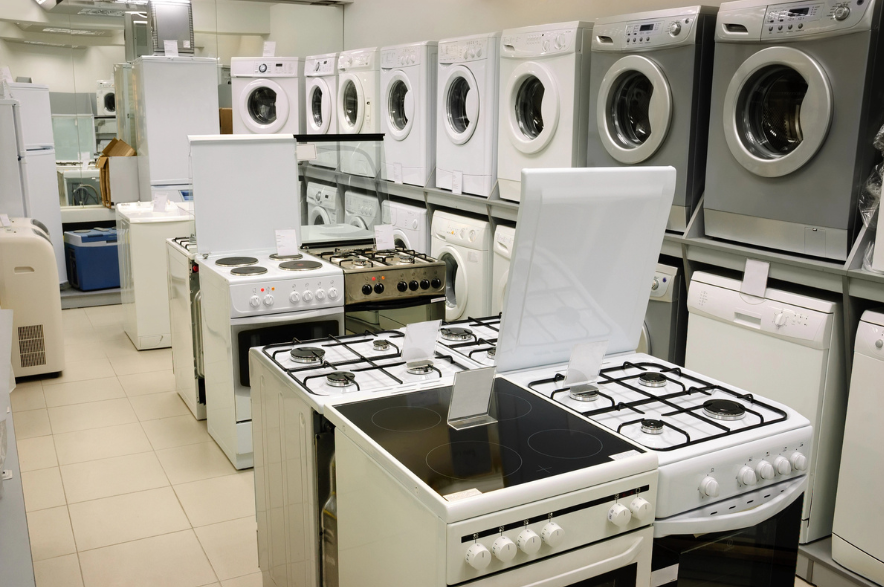 Washing machines, stoves and ovens selling in appliance store.