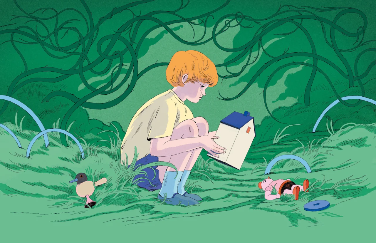 Child with orange hair sitting in lush green grass surrounded by vines, reading a blue book with toys scattered nearby