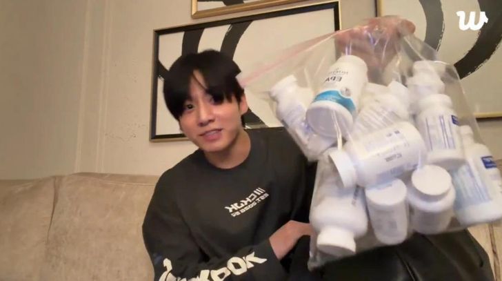 BTS member Jung Kook shows medications and supplements during a Weverse livestream. Captured from Jung Kook’s Weverse livestream