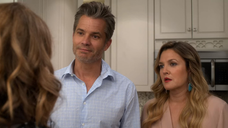 Timothy Olyphant and Drew Barrymore as Joel and Sheila standing in a kitchen in Santa Clarita Diet