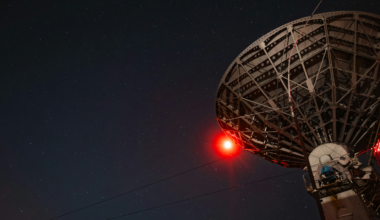 In 2019, astronomers linked eight radio observatories spread across four continents into a single virtual telescope the size of Earth, and after two years of assembling five petabytes of recorded data by hand, the combined instrument produced the first-ever photograph of a black hole’s shadow.