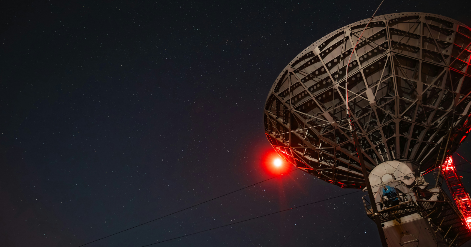 In 2019, astronomers linked eight radio observatories spread across four continents into a single virtual telescope the size of Earth, and after two years of assembling five petabytes of recorded data by hand, the combined instrument produced the first-ever photograph of a black hole’s shadow.