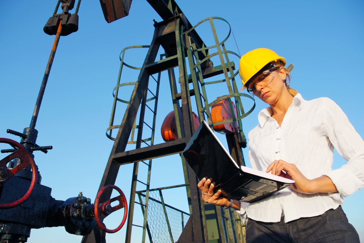A person in front of energy infrastructure.
