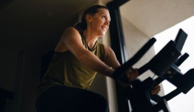 Woman doing cycling workout, smiling