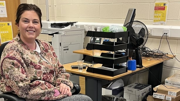 A woman sitting in an office