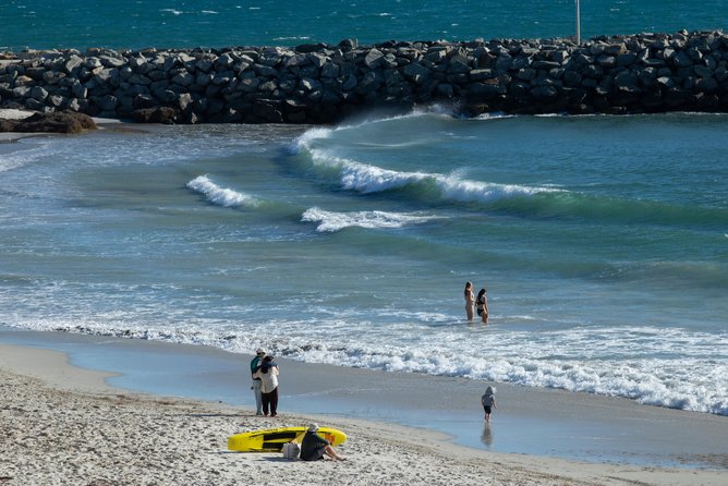 Pictures of some people still going into the water as Surf Life Savers were loud hailing the swimmers that the beach was closed at Cottesloe Beach, Perth. Picture: Ross Swanborough