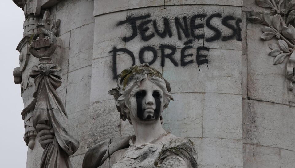 Tagging reading 'The golden youth' on the statue of Equality at the Republique square, after a quiet night Monday under curfew, the first since weekend protests over the cost of living turned into rioting and looting across France, in Paris, Tuesday, Oct. 20, 2026. (AP Photo/Christophe Ena)