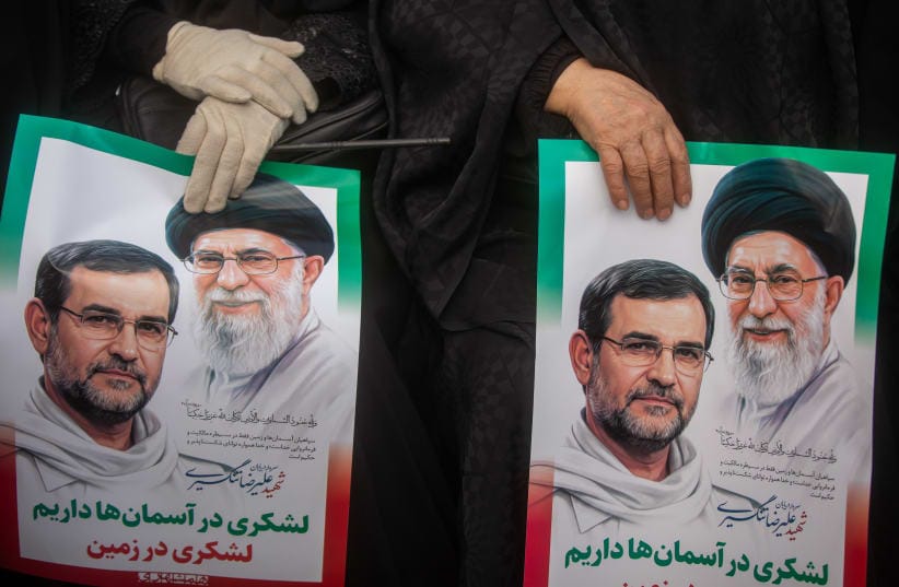 Posters featuring portraits of the late Alireza Tangsiri and Ayatollah Ali Khamenei are held by attendees of a funeral procession for IRGC Navy Chief Alireza Tangsiri, alongside other senior naval commanders and their families who were killed in US-Israeli strikes in late March, on April 1, 2026.