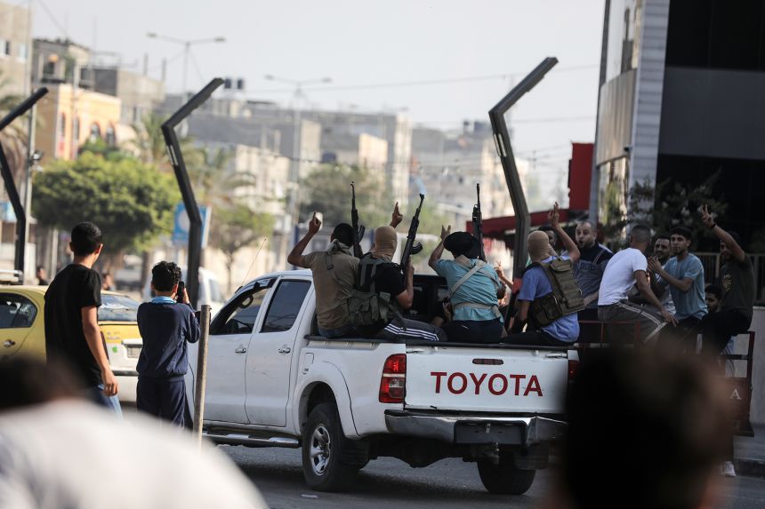Palestinian militants move towards the Erez crossing between Israel and northern Gaza on October 7, 2023.