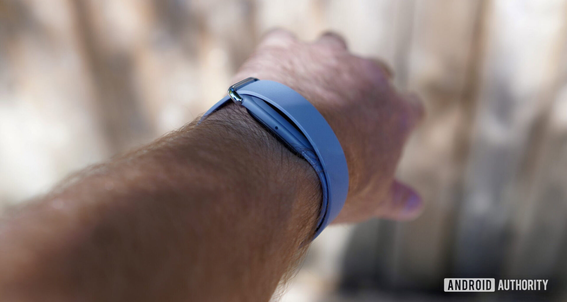 A person wearing a Fitbit Air, showing the side of the device.