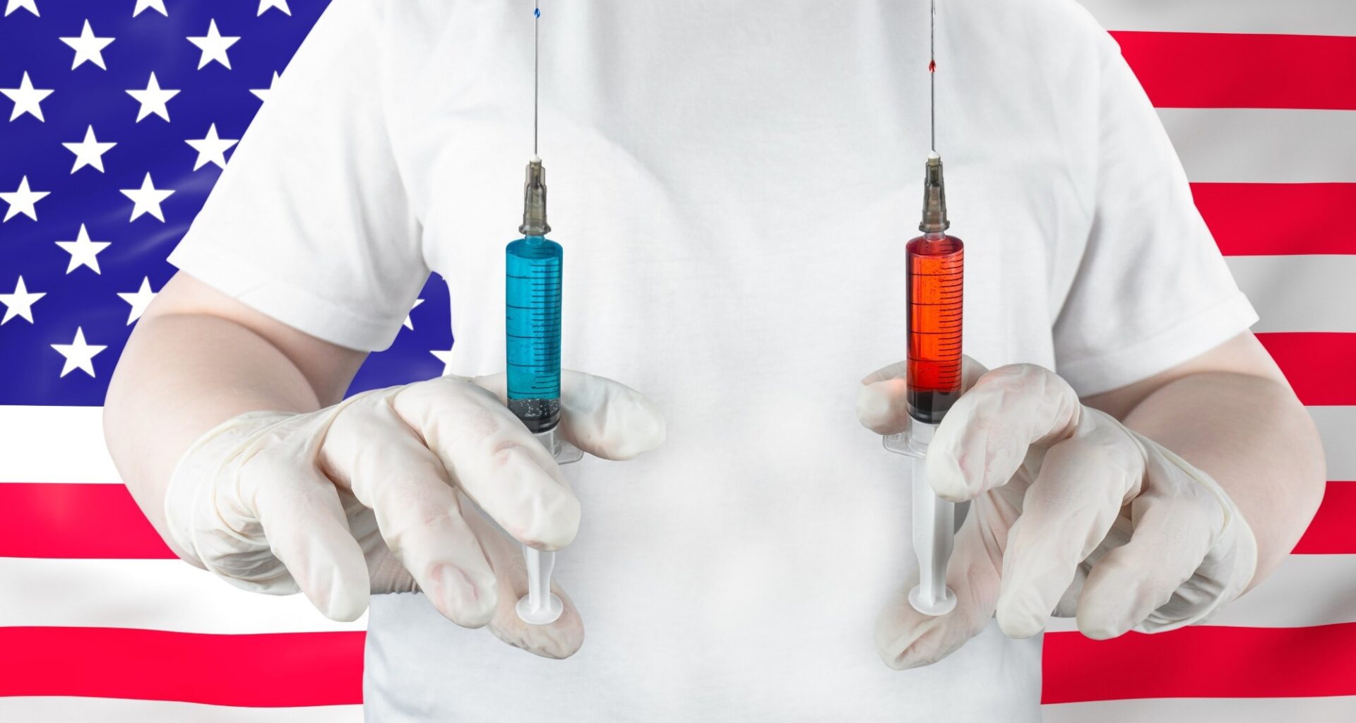 Medical worker in gloves holding syringes with blue and red liquid against American flag backdrop.