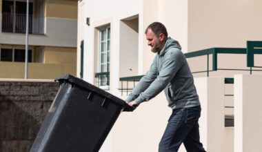 man pushing a trash can