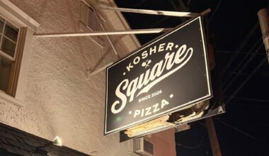Kosher Square Pizza's hanging storefront sign in Oakhurst, NJ