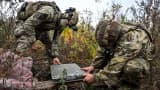 Soldiers from a separate task rifle battalion of the National Police of Ukraine in the Zaporizhzhia region set up a Starlink satellite communication terminal at a combat position in the Donetsk region, Ukraine, Oct. 16, 2026. 