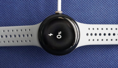 A charging Pixel Watch 2 displays the device's battery status at zero percent.